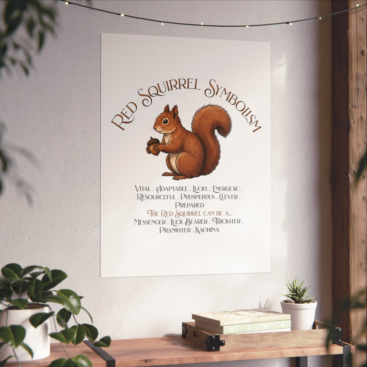 A vertical wall art print featuring a squirrel illustration and the text 'RED SQUIRREL SYMBOLISM' displayed in a styled interior setting with plants and a wooden console table.