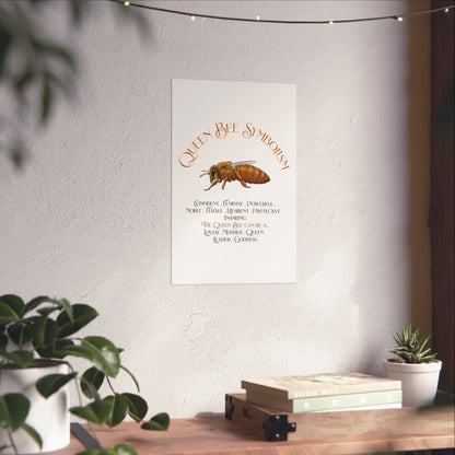 A vertical wall art print featuring a watercolor-style queen bee and the text 'Queen Bee Symbolism' with a list of qualities and roles, displayed on a light wall above a wooden shelf with plants and books.