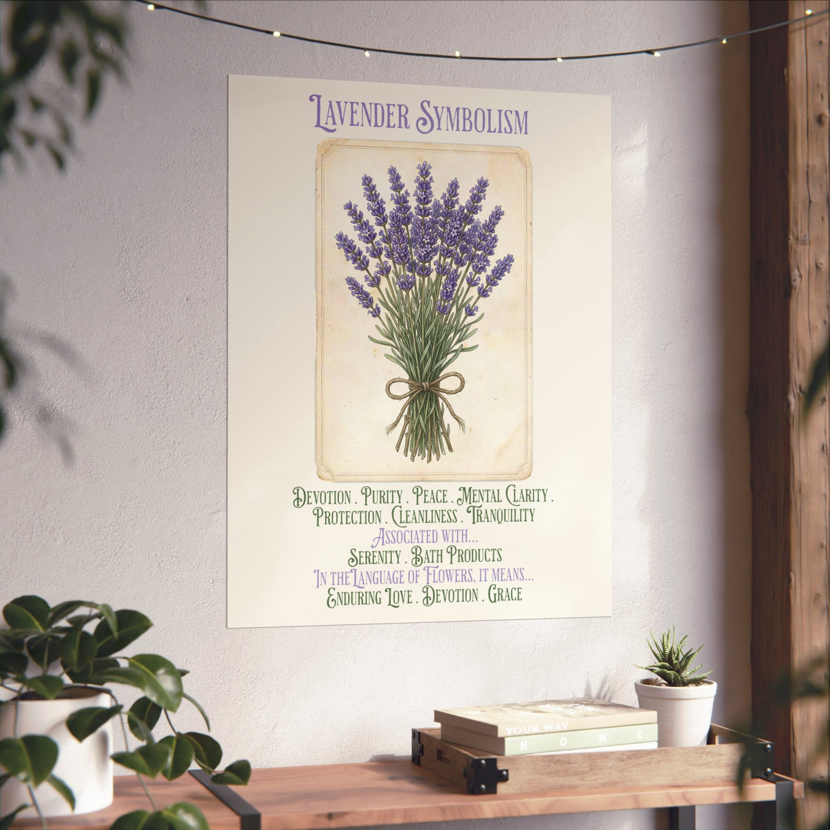 A framed lavender symbolism poster, hung on a light wall above a wooden shelf with books and small plants. The print shows a bouquet of lavender flowers with purple, green, and beige tones and decorative text.