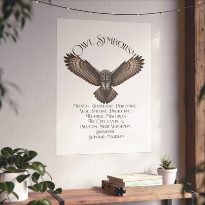 A vertical wall art print featuring a gray owl illustration and the text 'Owl Symbolism' displayed in a styled interior setting with plants and a wooden console table.