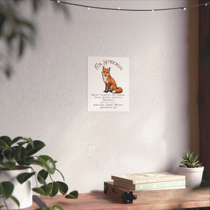 A vertical wall art print featuring a fox illustration and the text 'Fox Symbolism' displayed in a styled interior setting with plants and a wooden shelf.