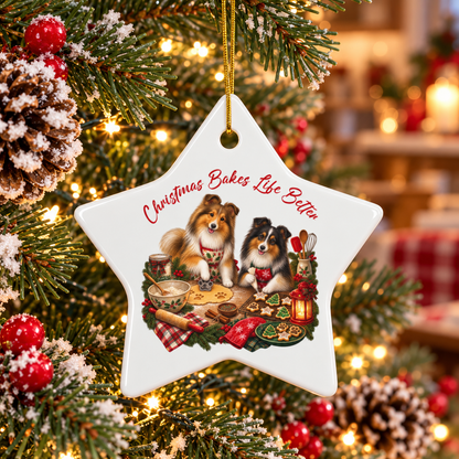 A white star-shaped Christmas ornament hanging on a decorated tree. The ornament features an illustration of two shelties baking together with the text 'Christmas Bakes Life Better' in red script.