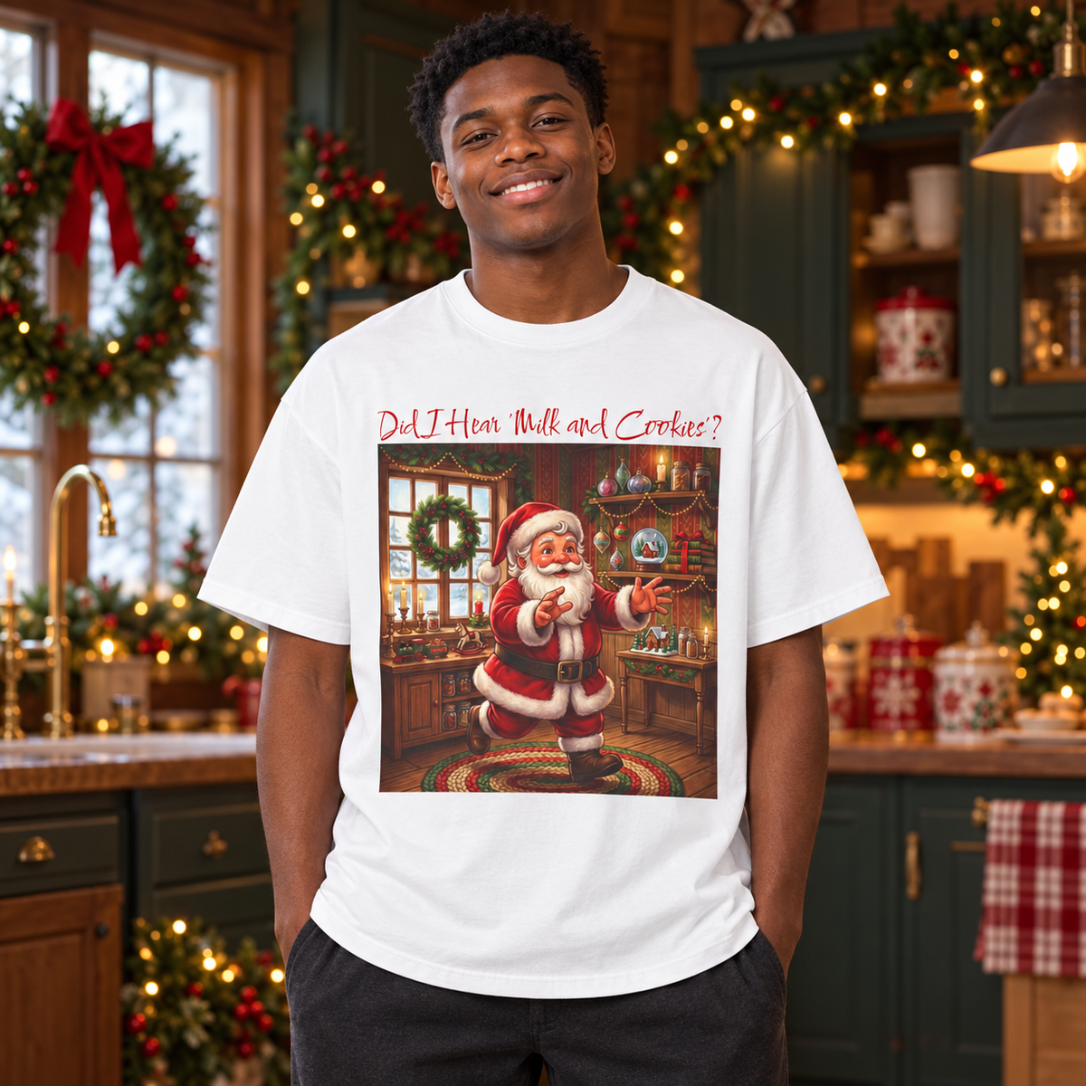 A man wearing a white graphic t-shirt with a Christmas-themed illustration of Santa Claus running and the text, "Did l Hear 'Milk and Cookies'?" The man is standing in a decorated holiday kitchen setting.