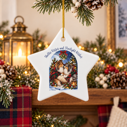 A white star-shaped Christmas ornament hanging from a pine branch, featuring an illustration of two Shelties under a blue night sky with holly and the text 'Sheltie Kisses and Starlight Wishes.' The background shows a cozy holiday scene with candles, pinecones, and warm lights.