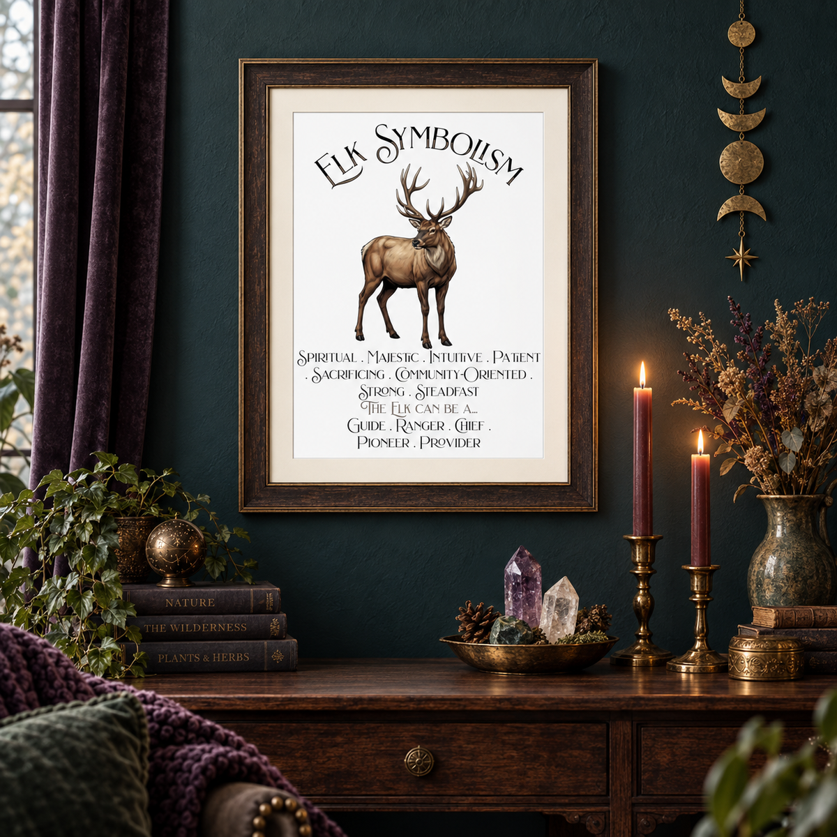 A framed art print featuring an elk illustration and 'ELK SYMBOLISM' text, displayed on a dark teal wall above a wooden console table in a styled room setting with candles, crystals, and plants.
